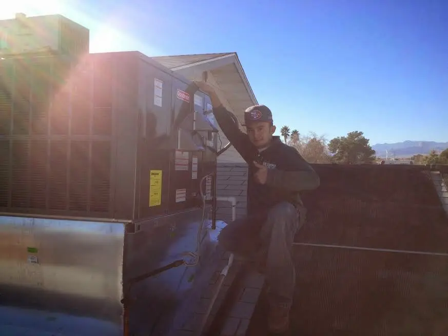 HVAC technician performing HVAC Inspection on a rooftop unit in Lackawaxen